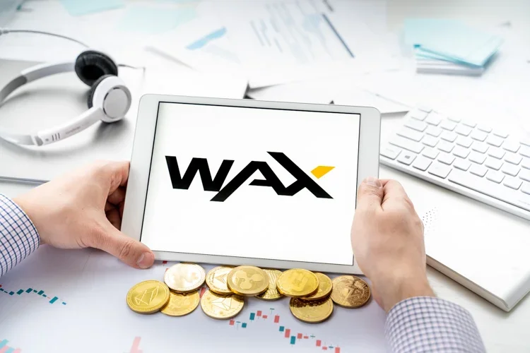 Логотип WAX открыт с экрана планшета.